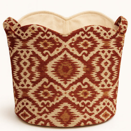 Decorative tote basket bag with red and beige ikat pattern on a white background